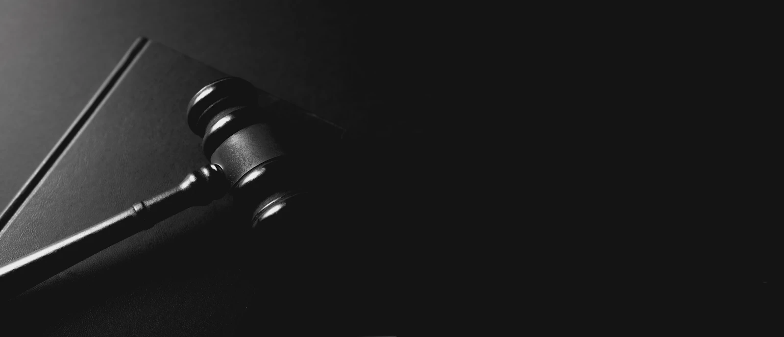 Wooden judge's gavel resting in a courtroom setting