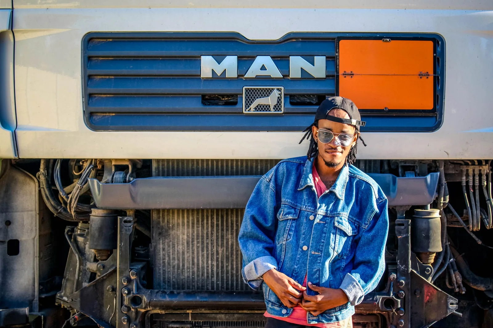 Professional commercial driver standing in front of a truck